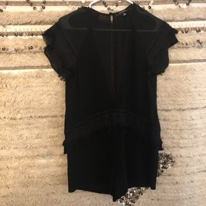 Black romper with sheer and tassel details